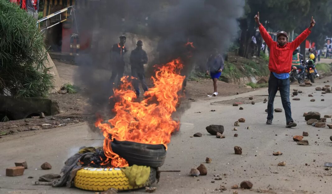 Protesters light bonfires during public transport strike in Kenya over fuel prices